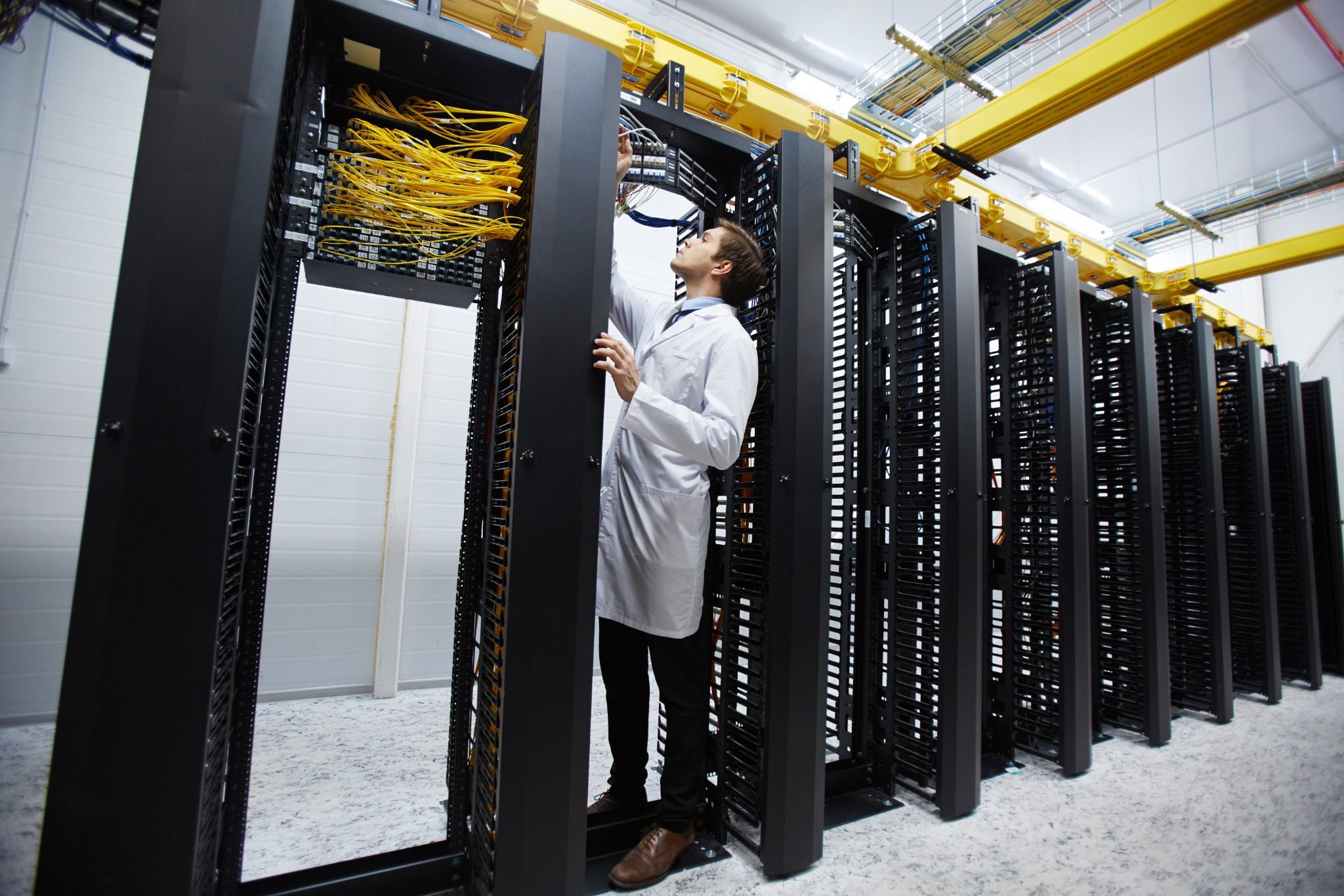 Electrical switchgear undergoing inspection at an off-site logistics facility before shipment to a data center